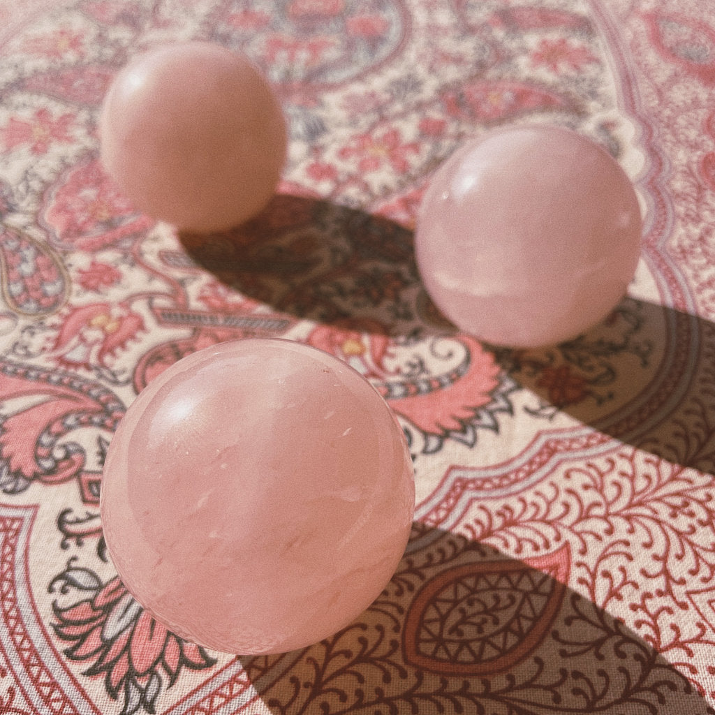 3 rose quartz balls of Akasha blends on a nice pattern background